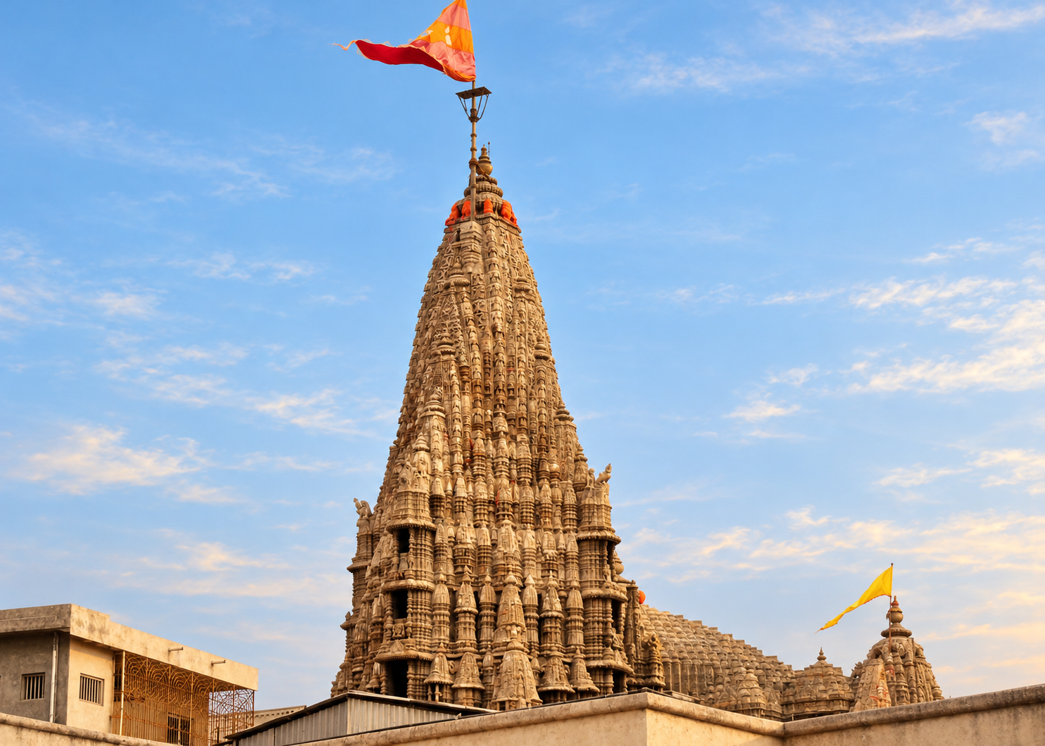 The carved tower and flags of the present Dwarkadhish Temple, with no people visible.